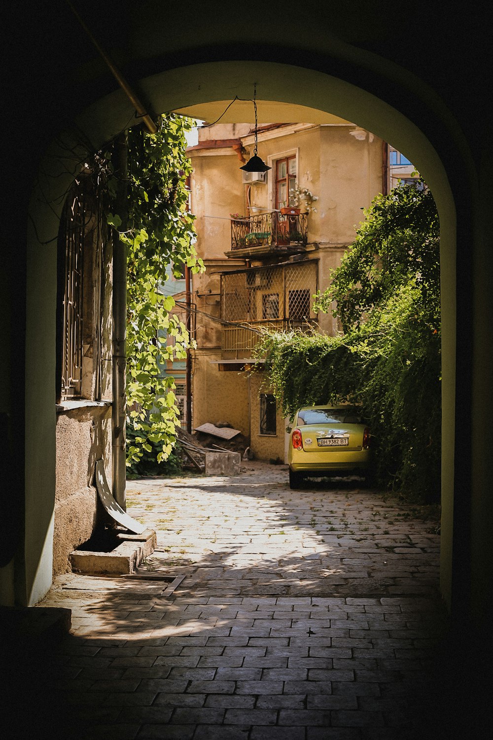 a car is parked on a cobblestone street