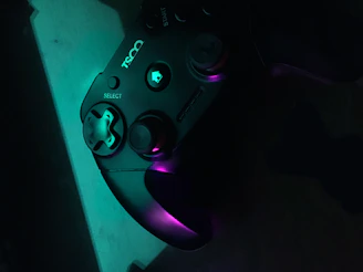 Close-up of a custom Xbox controller with purple LED accents glowing in a dark room