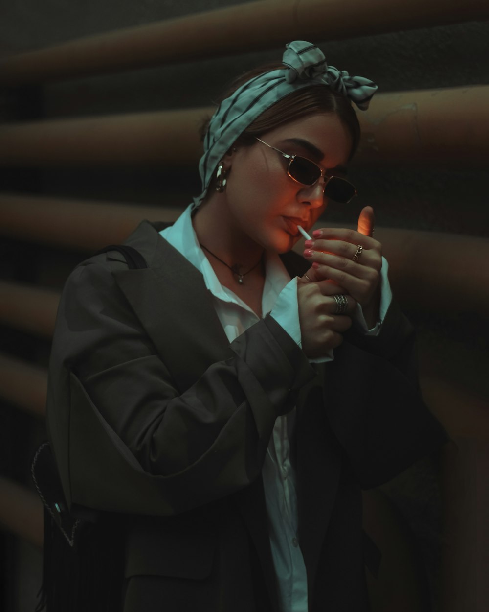 a woman in a turban smoking a cigarette