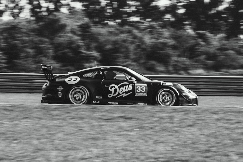 a black and white photo of a racing car