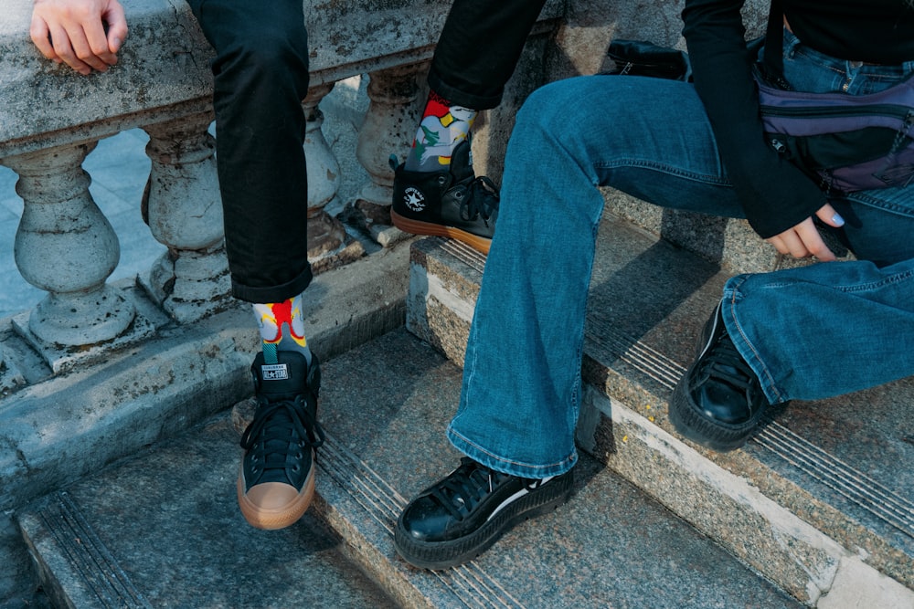 a couple of people that are sitting on some steps