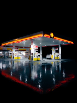 a gas station lit up at night time