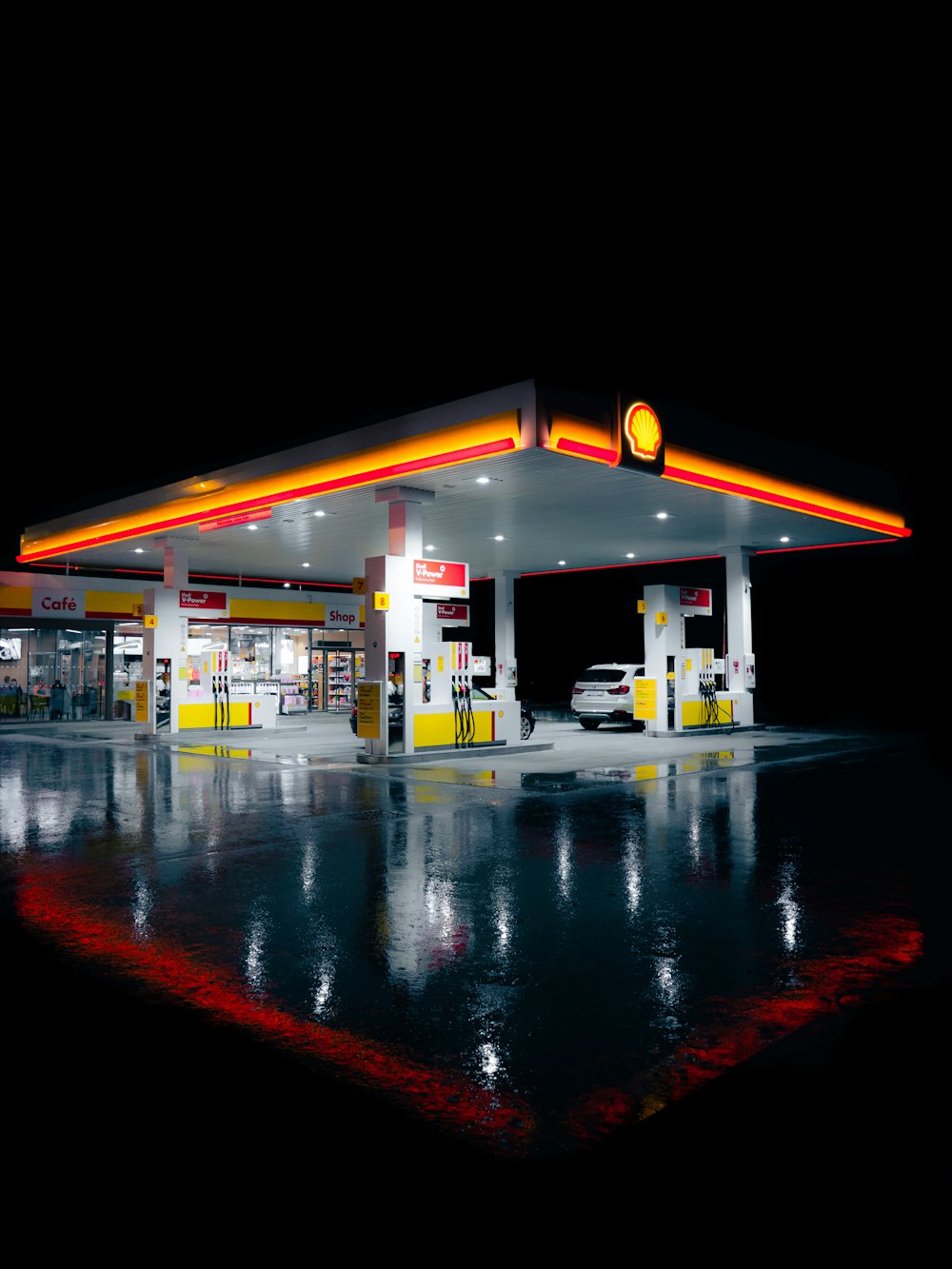 a gas station lit up at night time