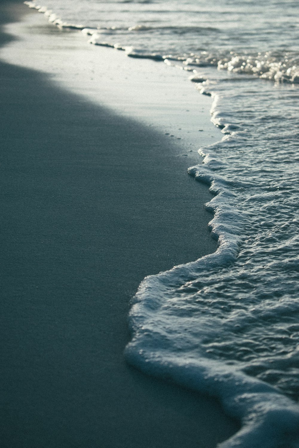 a close up of a wave on a beach