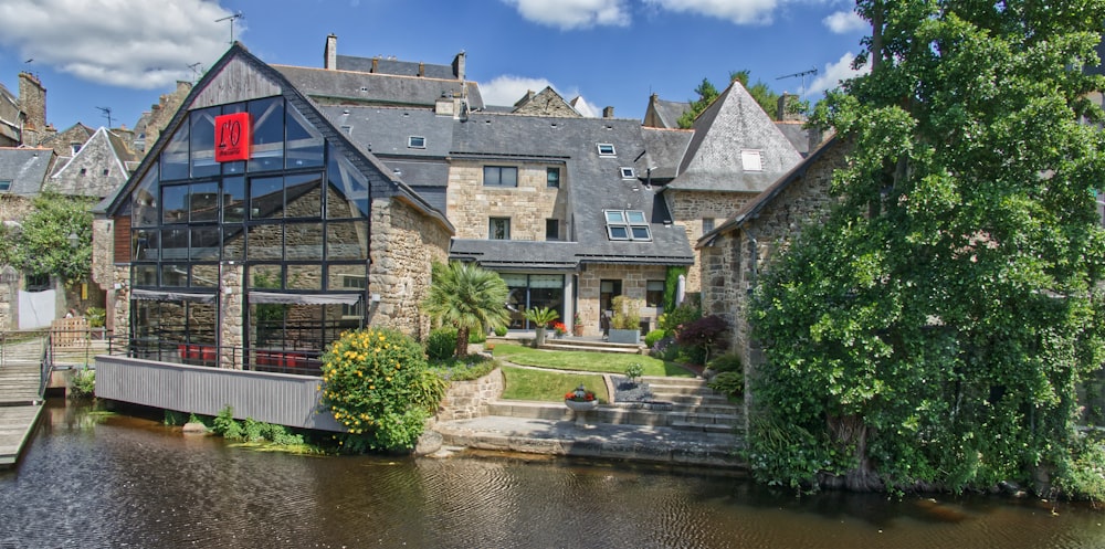 a large house sitting next to a body of water