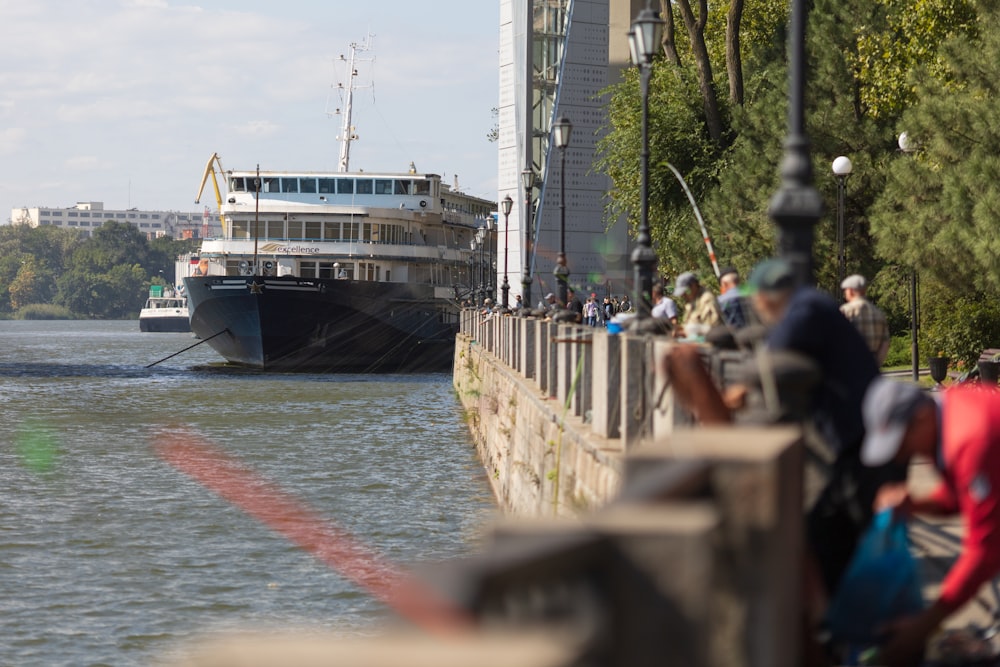 a large boat traveling down a river next to tall buildings