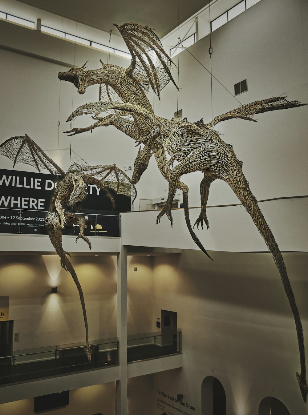 a sculpture of a flying bird in a museum