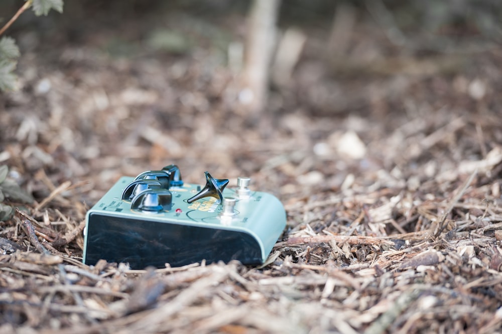 a blue box sitting in the middle of a forest