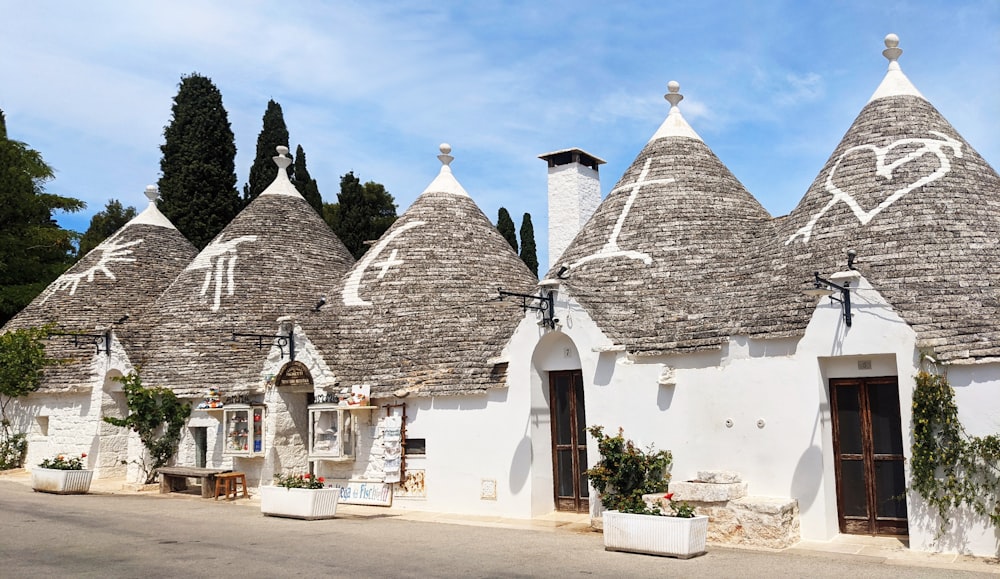 a row of white houses with thatched roofs