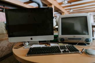 a computer monitor sitting on top of a wooden desk