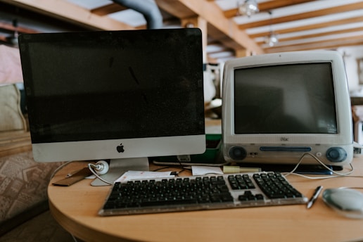 a computer monitor sitting on top of a wooden desk