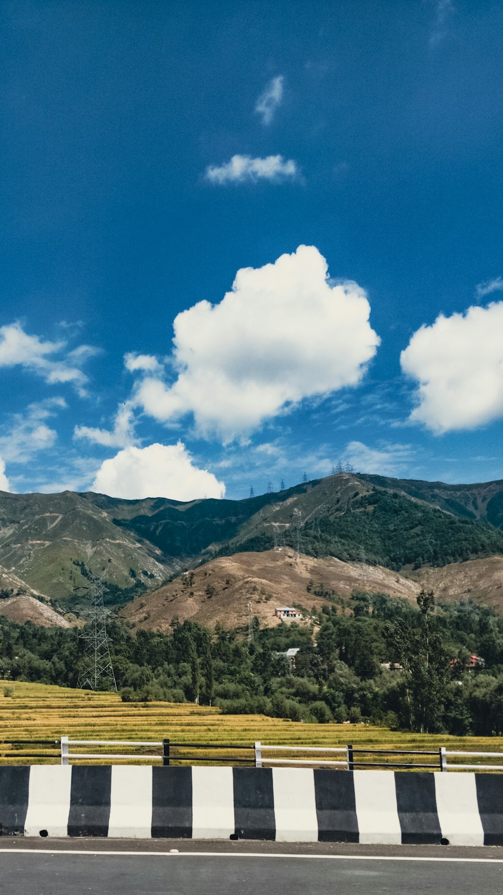 a view of a road with mountains in the background