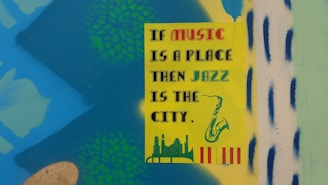 A colorful poster with the text 'If music is a place, then jazz is the city' in various fonts. The poster has illustrations of a saxophone, a city skyline, and decorative patterns in the background. The background is a bright mix of blue, green, and yellow with some abstract shapes.