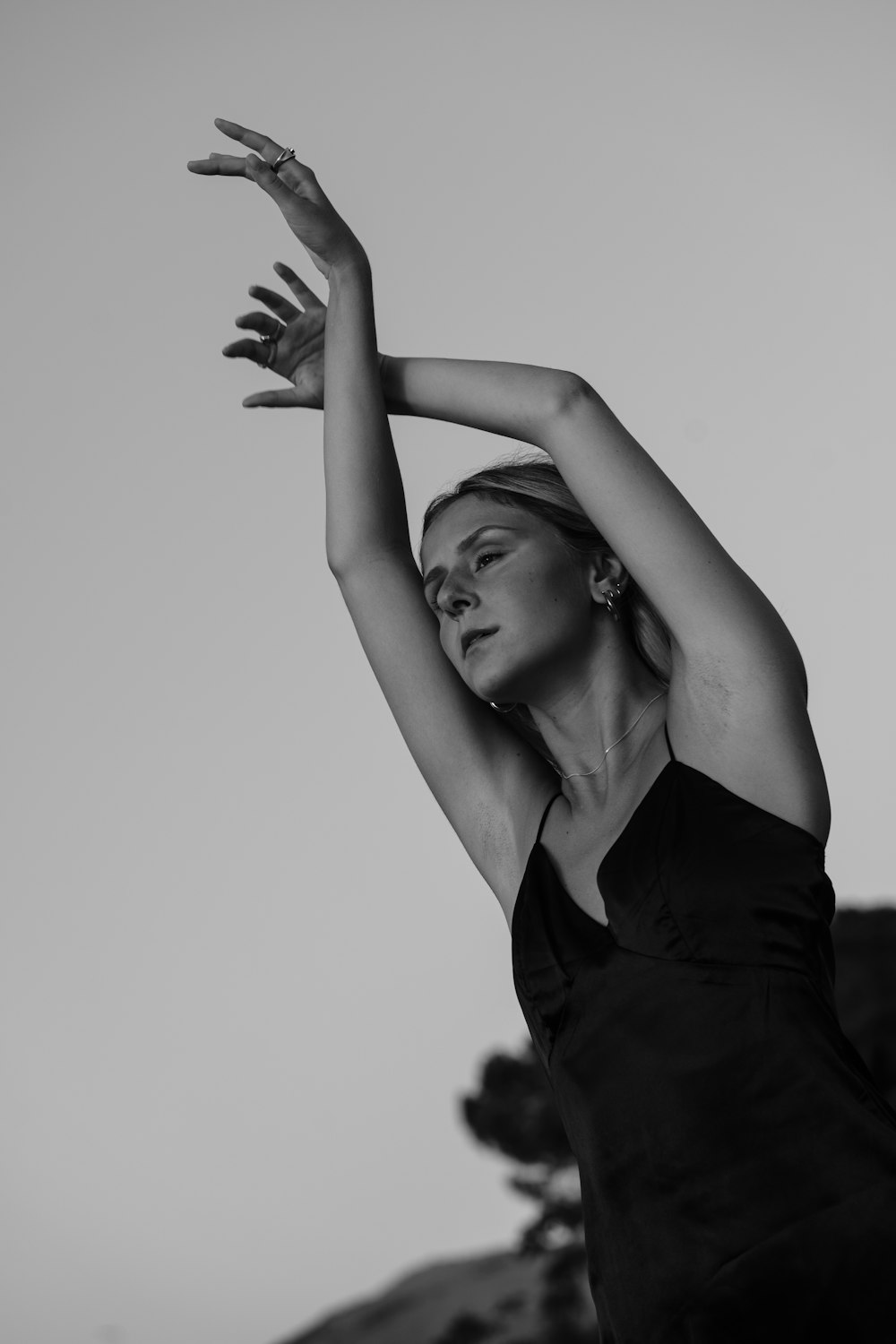 a black and white photo of a woman in a dress