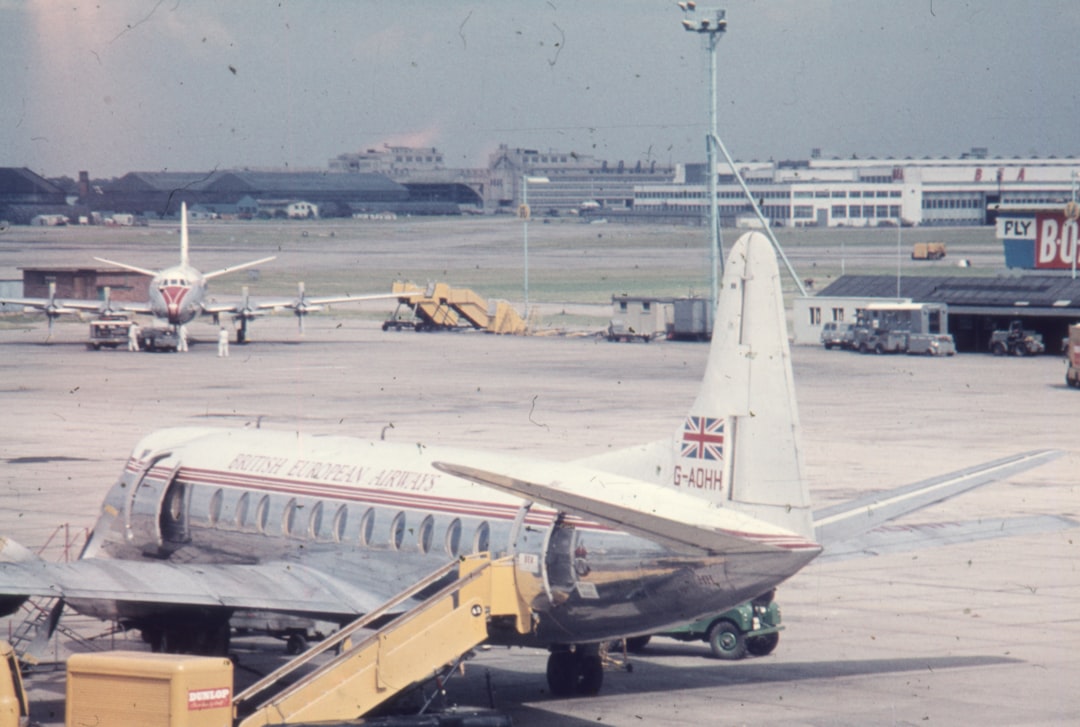 an airplane parked on the tarmac at an airport, London airport 1960