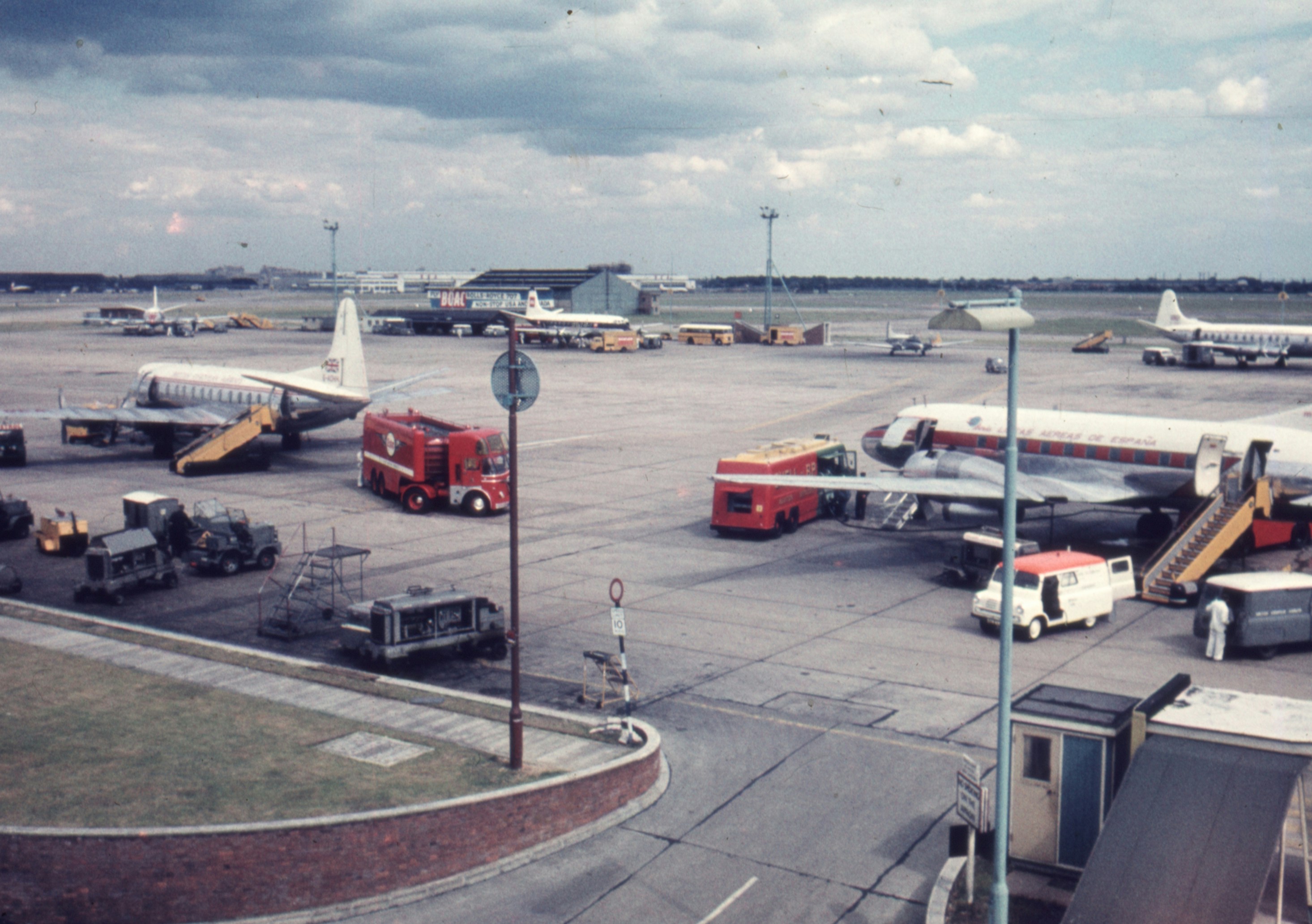 a group of airplanes parked on top of an airport tarmac, London airport 1960