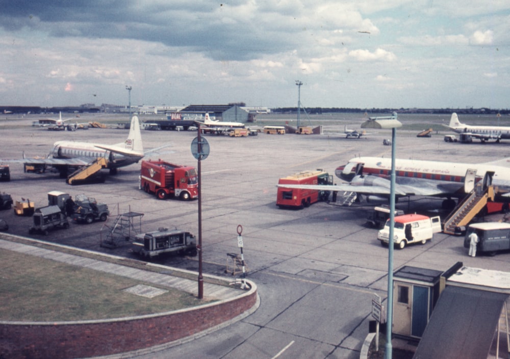 a group of airplanes parked on top of an airport tarmac