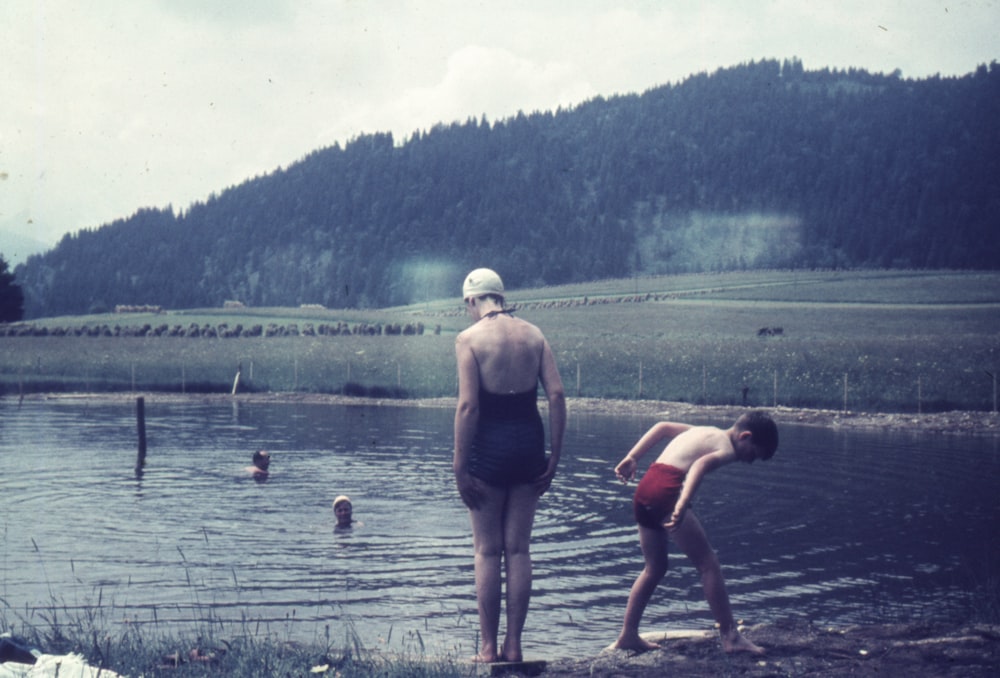 a person standing next to a body of water