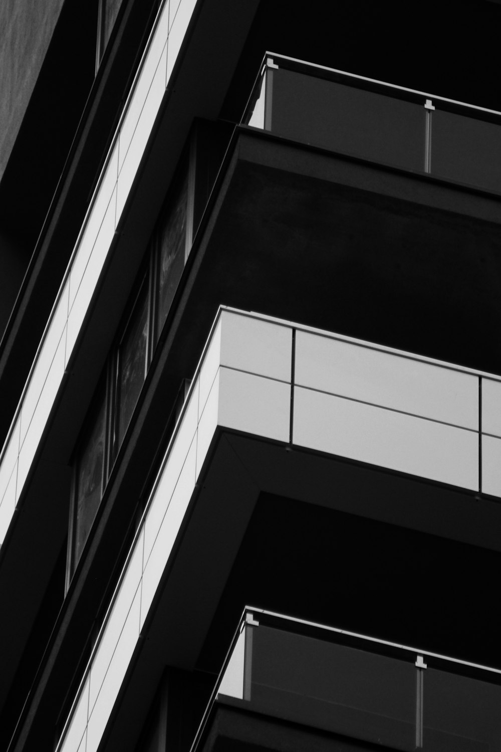 a black and white photo of a building with balconies