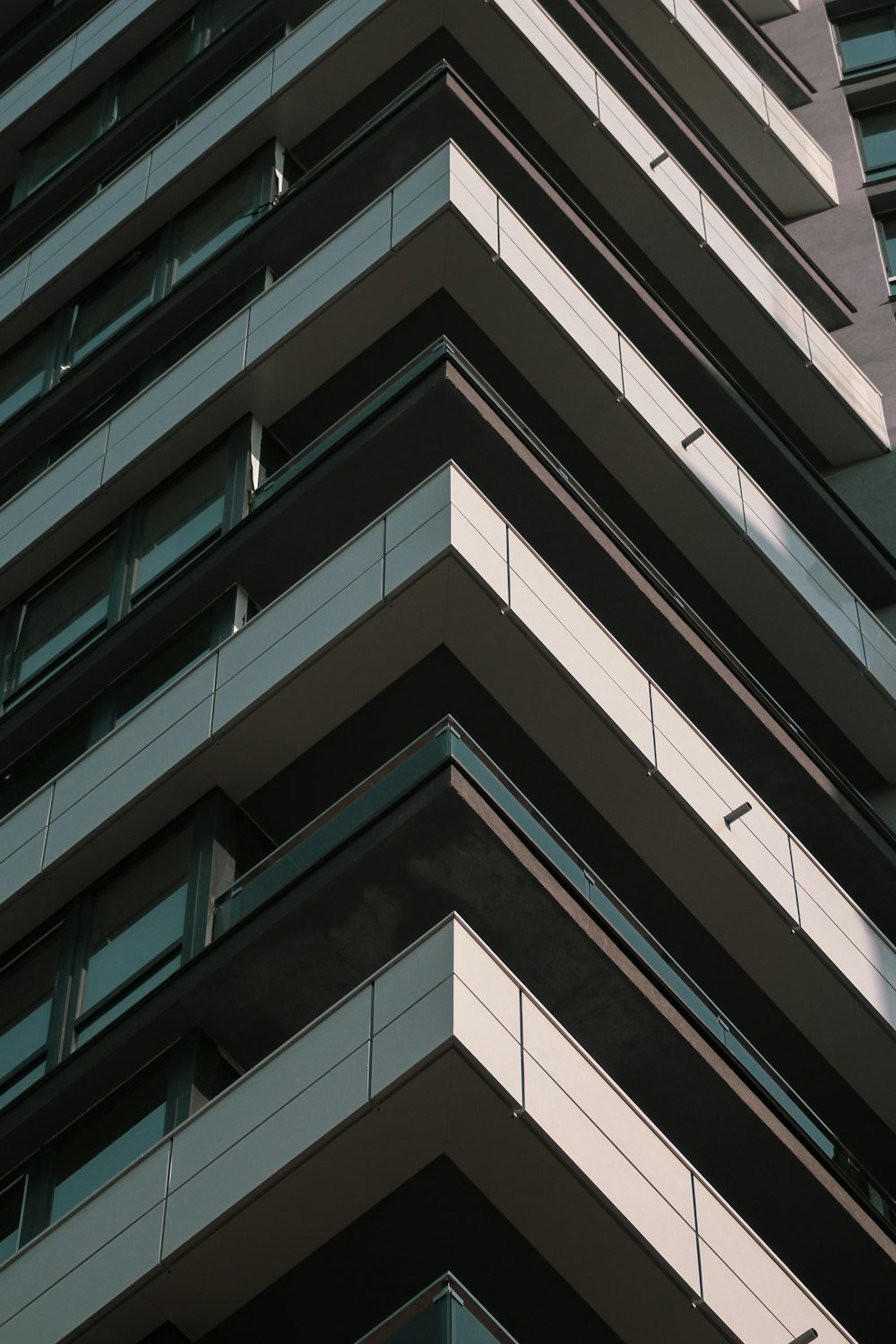 a tall building with many windows and balconies