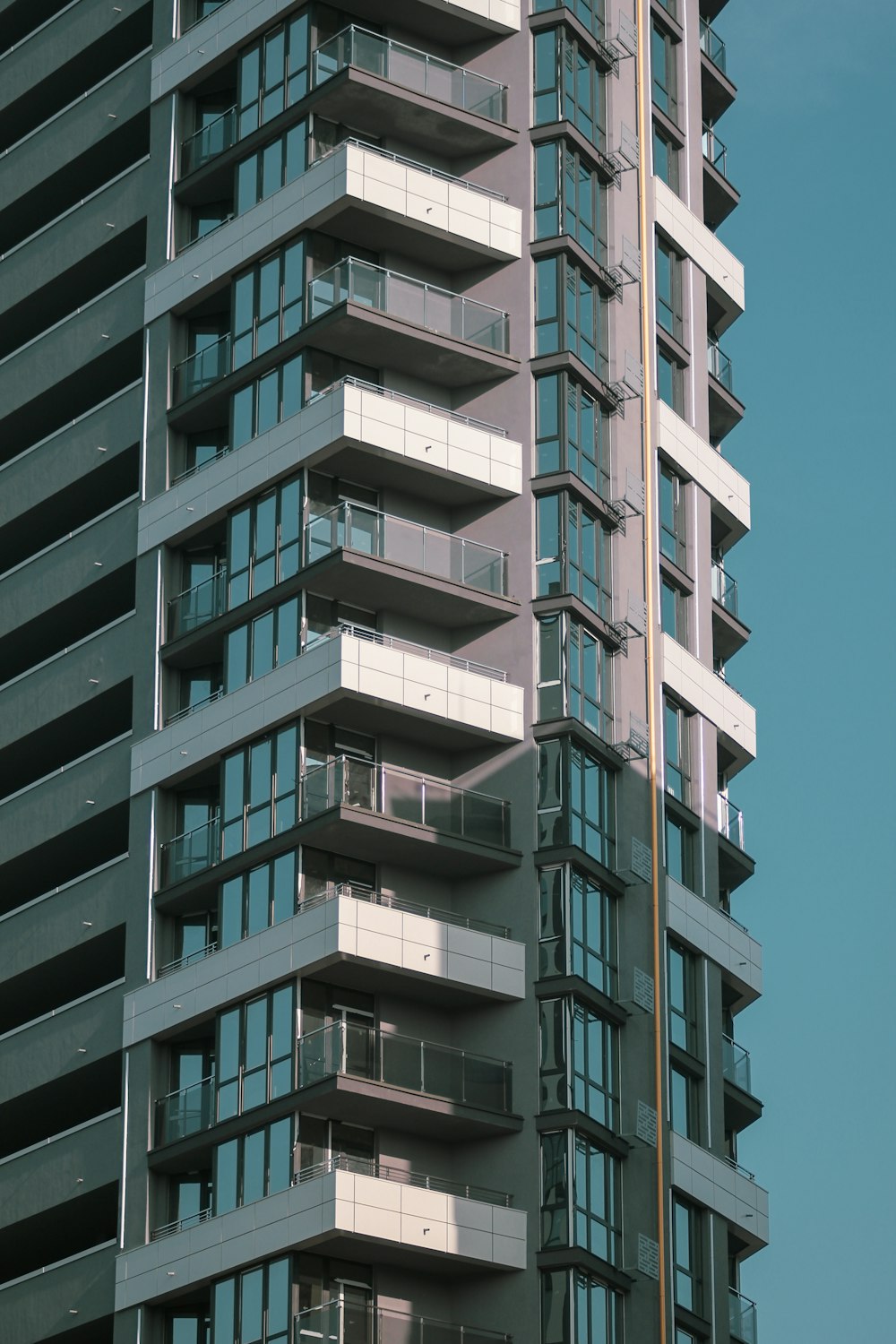 a tall building with balconies on top of it