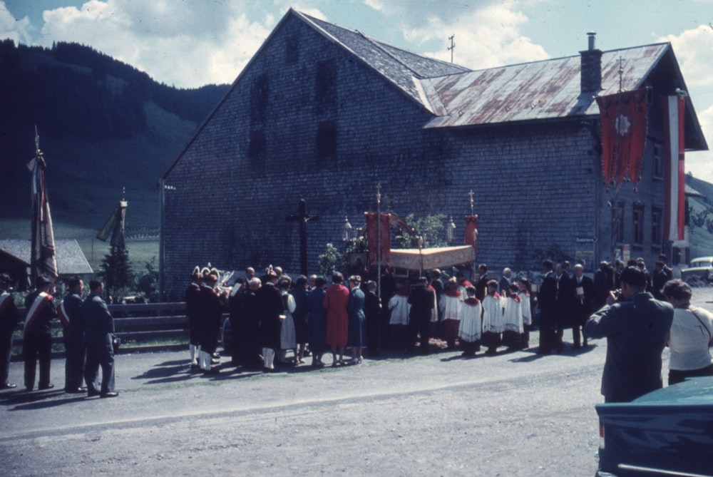 a group of people standing in front of a building