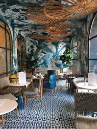 a blue and white room with chairs and tables