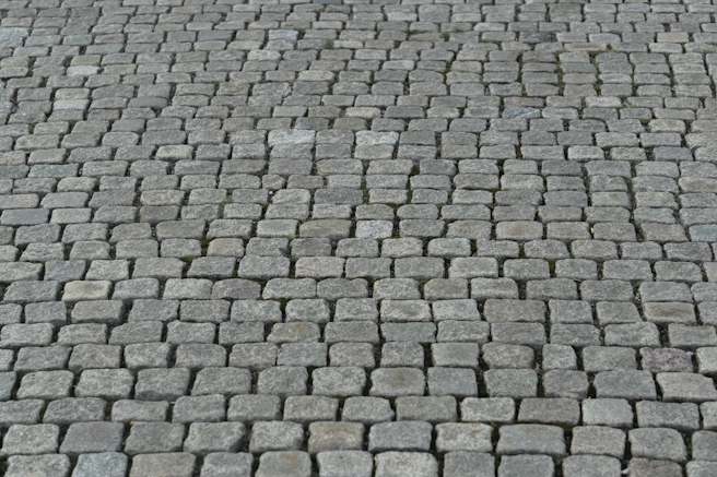 a close up of a brick road with a stop sign on it