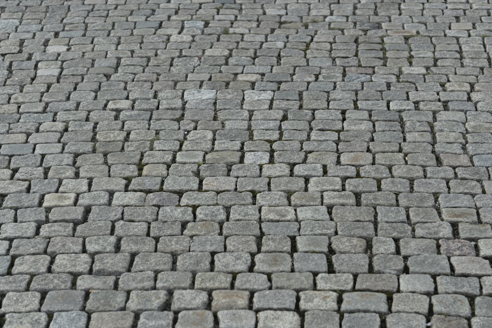 a close up of a brick road with a stop sign on it