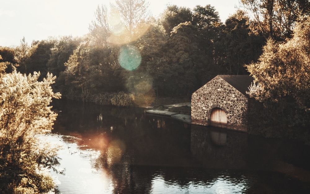 a small building sitting on the side of a river