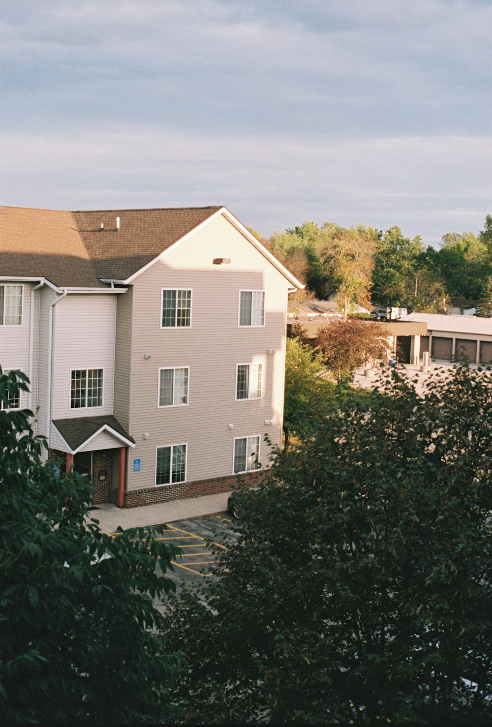 an apartment building with a parking lot in front of it