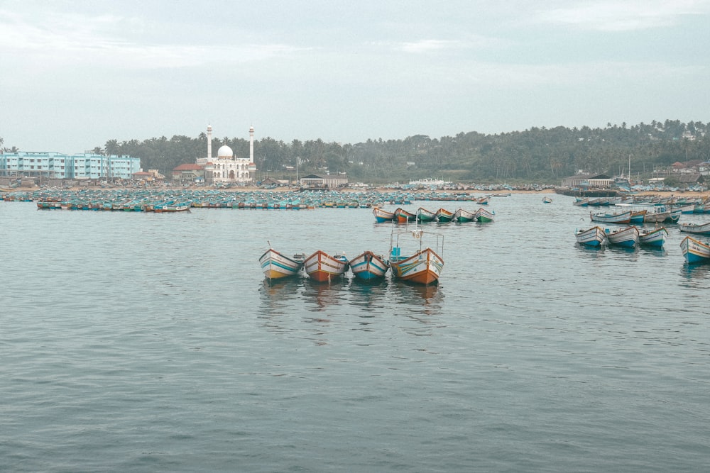 a group of boats floating on top of a large body of water