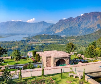 a scenic view of a park with mountains in the background