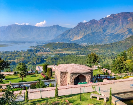 a scenic view of a park with mountains in the background