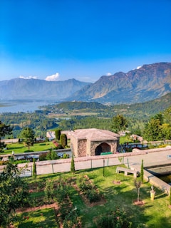 a scenic view of a park with mountains in the background