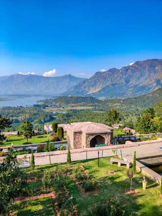 a scenic view of a park with mountains in the background
