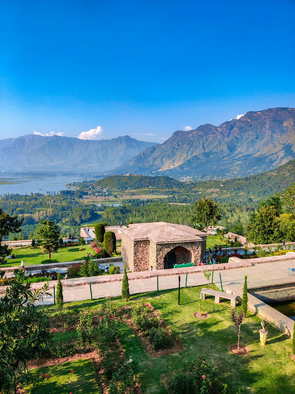 a scenic view of a park with mountains in the background