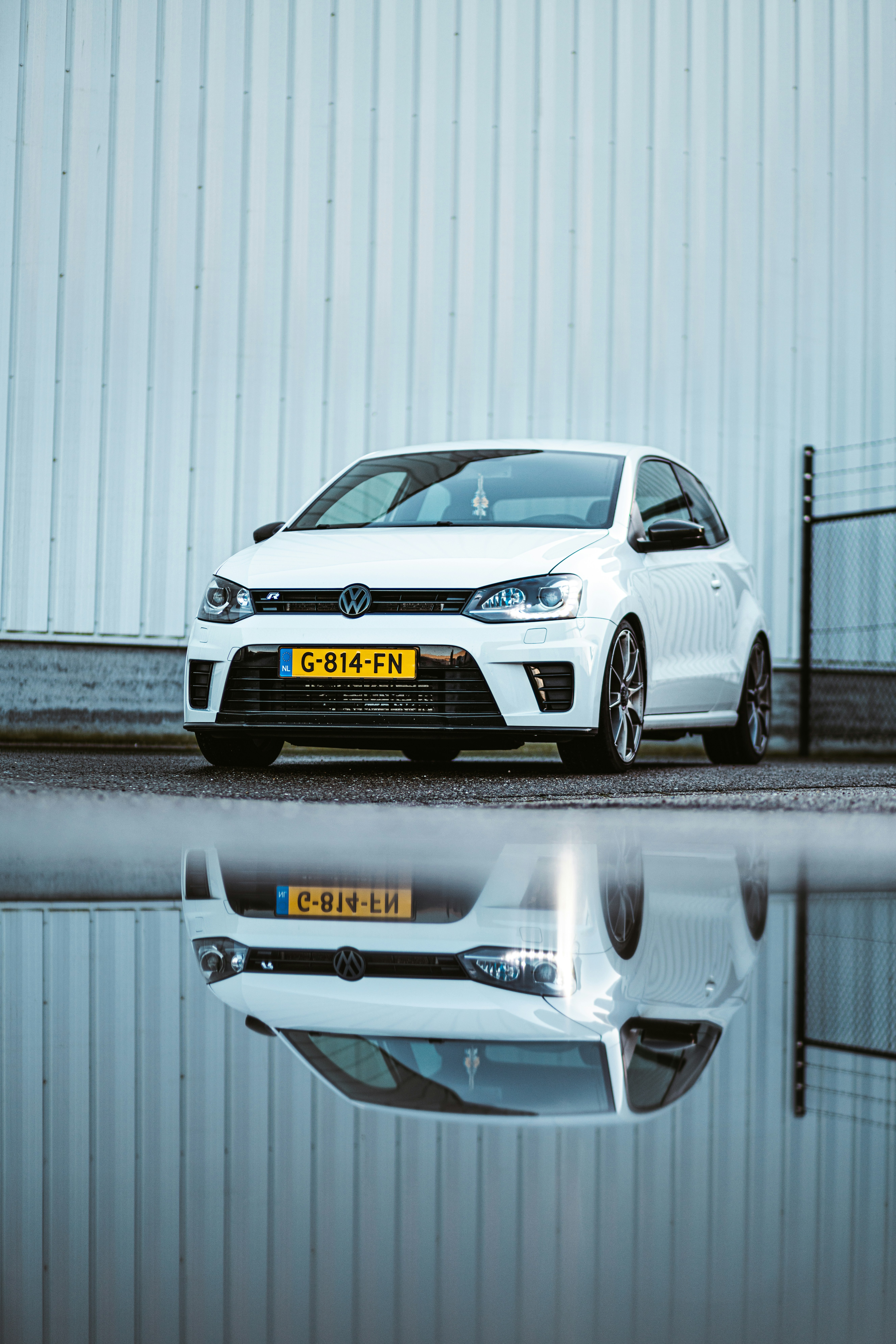 A white car parked in front of a building photo – Free Car Image on ...