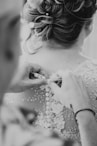 a woman in a wedding dress getting ready