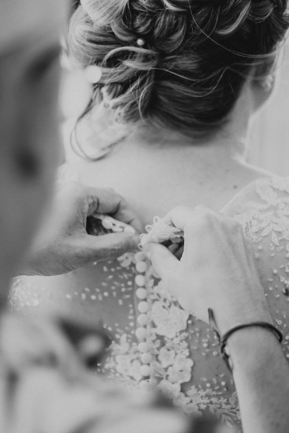 a woman in a wedding dress getting ready