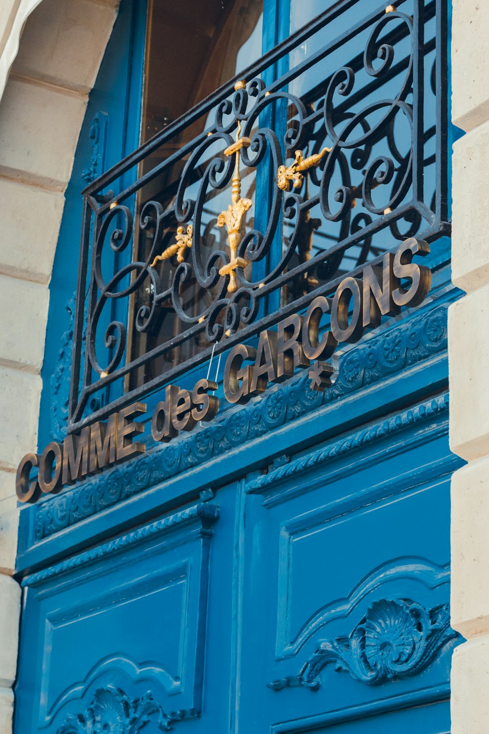 a blue door that has a clock on it