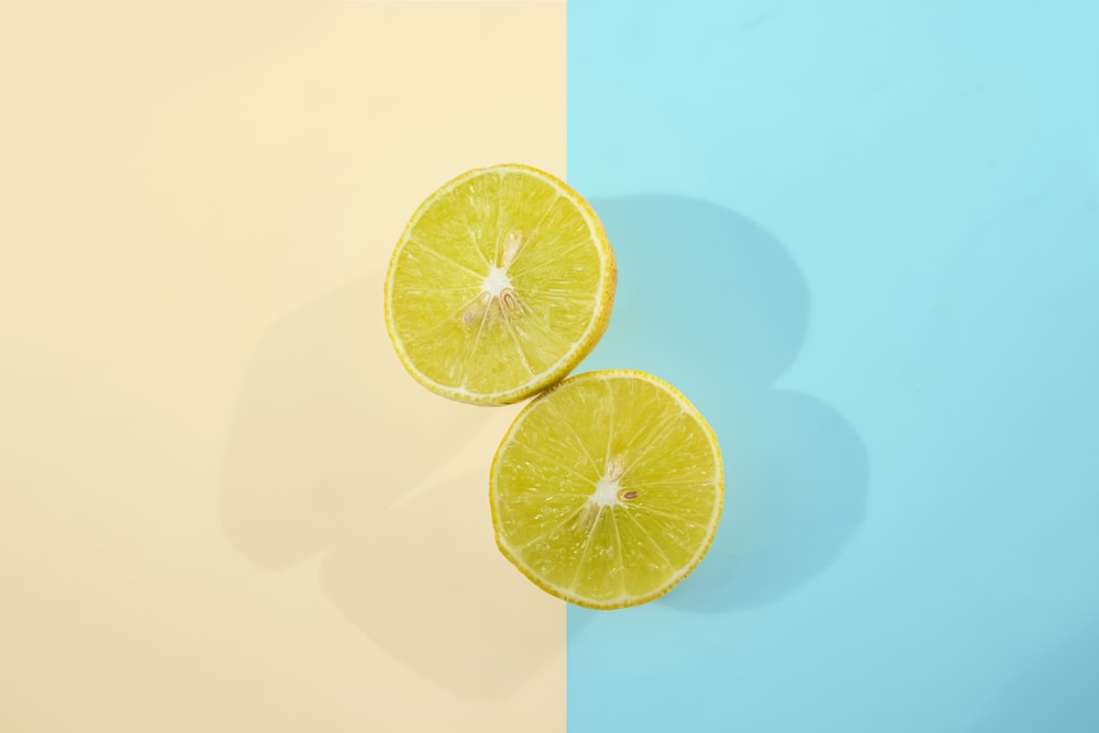 two halves of a lemon on a blue and yellow background