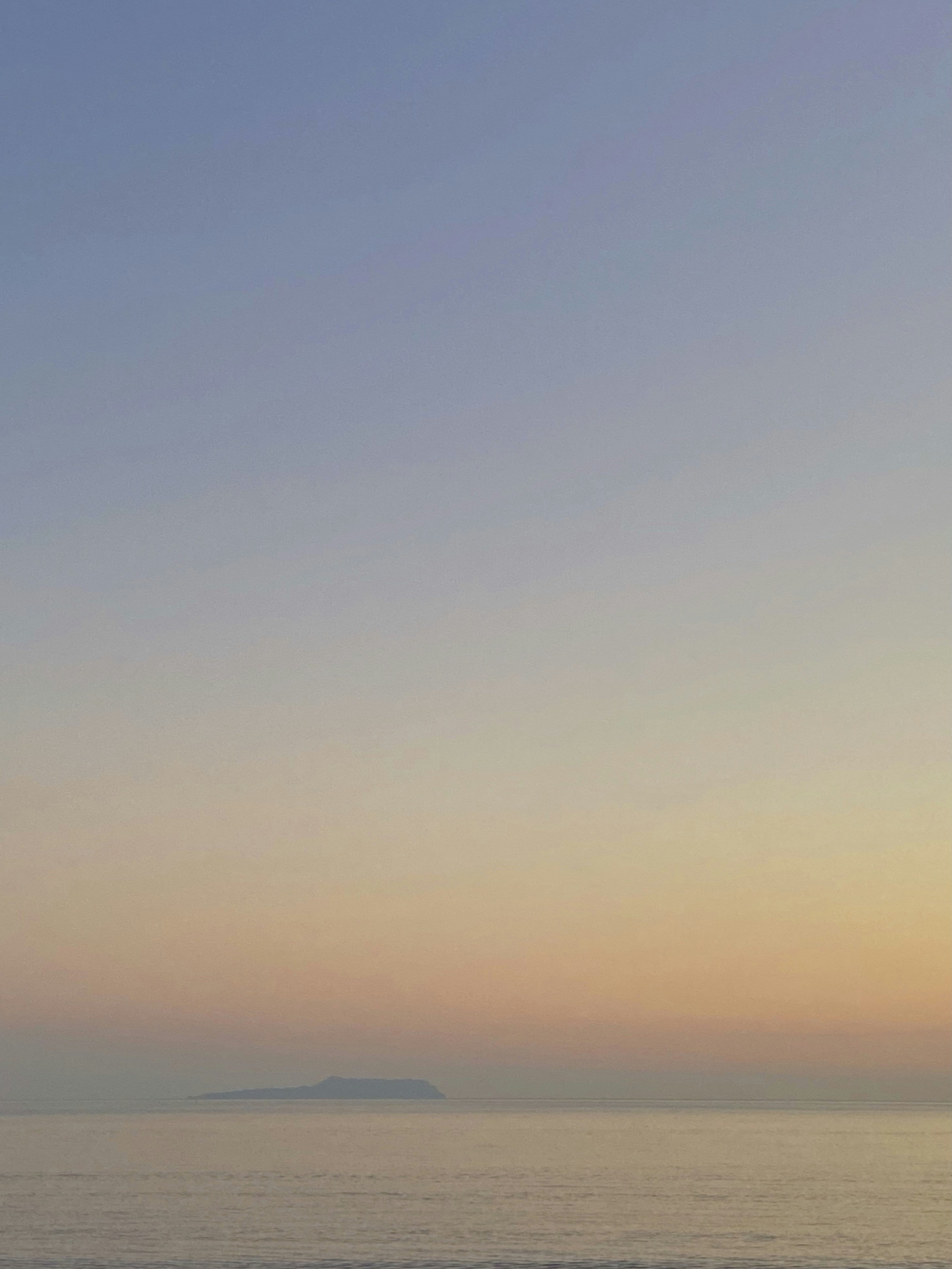 a person walking on the beach at sunset