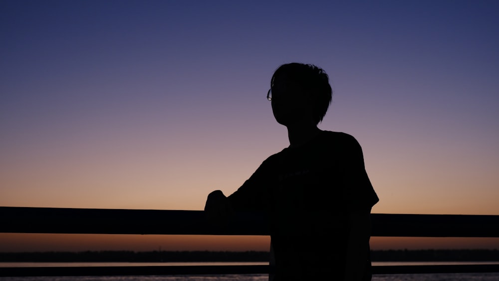 a person standing in front of a body of water