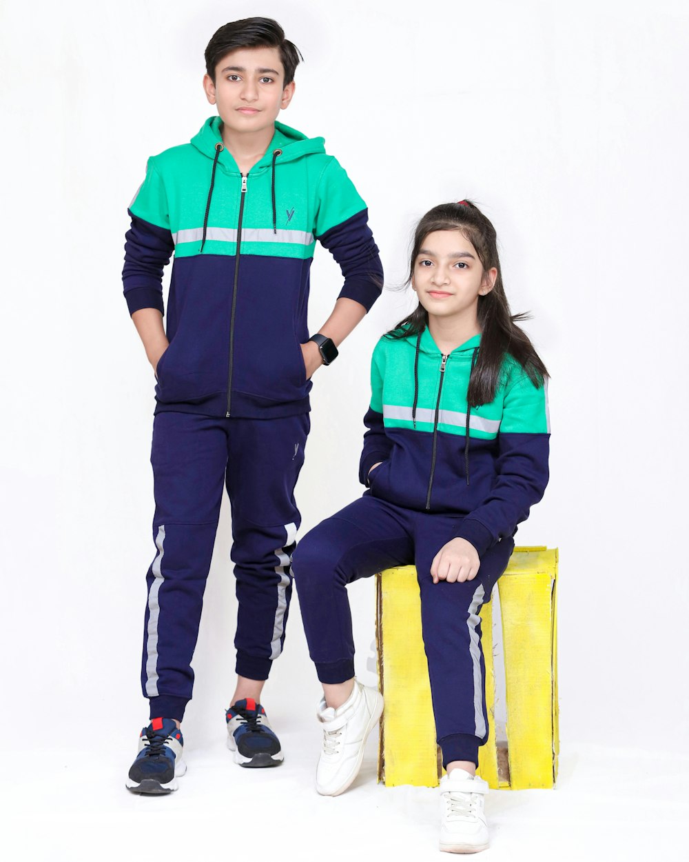 a boy and a girl in matching tracksuits