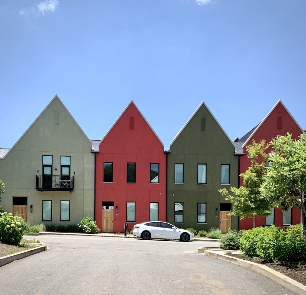 a car parked in front of a row of houses