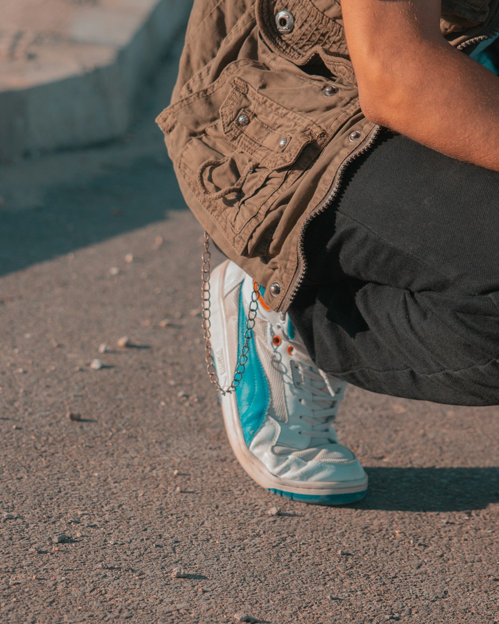 a person squatting down with their shoes on