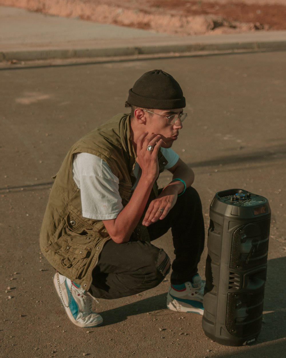 a man kneeling down next to a trash can