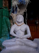 A person meditating peacefully surrounded by symbols of African heritage.