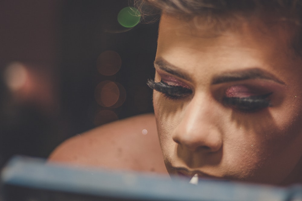 a close up of a woman's face with makeup